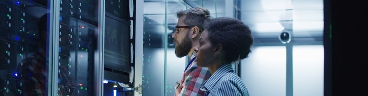 This image shows IT professionals monitoring servers within a data center environment