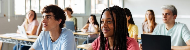 image shows a classroom setting with students engaged in learning